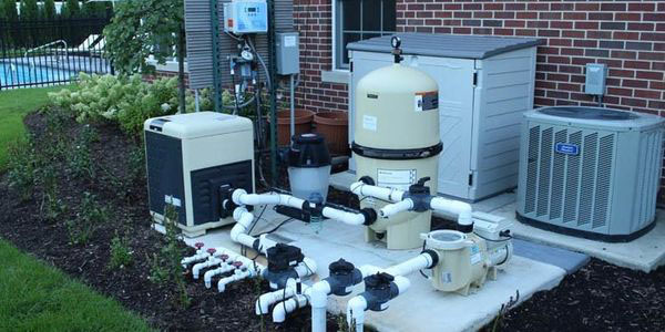Pool equipment pad with pump, filter, and heater serviced by Integrity Pools
