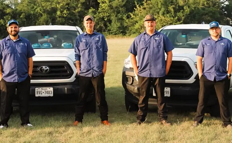 The licensed Integrity Pools repair team standing with their service trucks in Dallas–Fort Worth